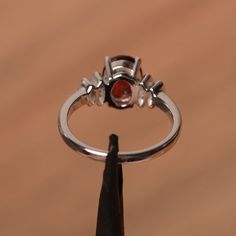 It is natural garnet ring. The main stone is 7mm*9 mm oval cut.weight about 2.33 carats. The basic metal is sterling silver and plated with rhodium. To change the metal to a solid gold (white/rose) or platinum is also available, please ask for a quotation if you want. You can also go to my shop Home for more elegant rings: https://www.etsy.com/shop/godjewelry?ref=hdr_shop_menu Emerald is January birthstone More garnet rings: https://www.etsy.com/shop/godjewelry?ref=l2-shopheader-name§ion_id=2070 Oval Ruby Ring With Prong Setting In Sterling Silver, Oval Garnet Jewelry With Prong Setting, Oval Ruby Ring In White Gold Sterling Silver, Oval Garnet Jewelry With Halo Setting, Silver Oval Garnet Birthstone Ring, Oval Garnet Birthstone Ring In Silver, Oval Garnet Ring In Silver, Oval Silver Garnet Birthstone Ring, Oval Silver Ruby Promise Ring