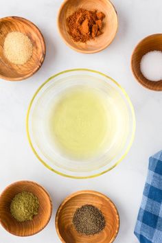 bowls filled with different types of spices on top of a table