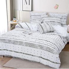 a white bed with black and white patterns on it