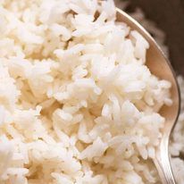 a spoon full of rice sitting on top of a table