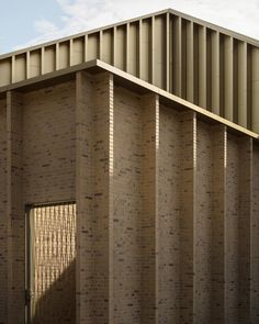 the side of a brick building with an open door