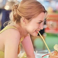 a woman is smiling while eating some food