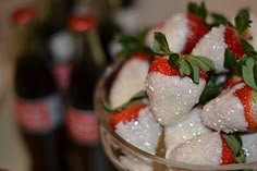 some strawberries are sitting in a glass bowl