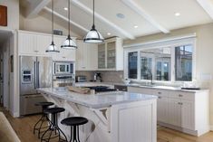 a kitchen with an island and three stools