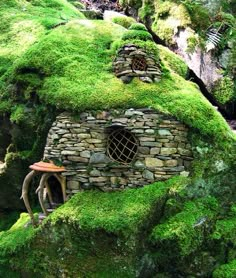 a small house made out of mossy rocks