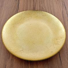 a yellow plate sitting on top of a wooden table