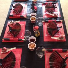 the table is set with red and black napkins