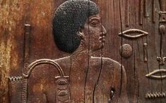 an ancient carving on the side of a wooden door