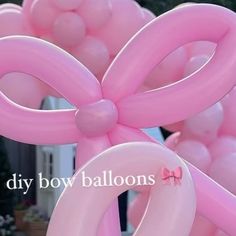 pink balloons are arranged in the shape of a bow and ribbon for a balloon arch