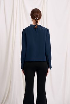 Everyone's favourite modern vintage style Buvette Pearl blouse now updated in a midnight-blue hue, featuring gently puffed sleeves, french cuffs and our signature pearl embellishment at the collar. Wear yours with a neutral coloured bottom and a bold red lip. Fabric: Soft, smooth and medium weight on the skin. Machine wash gentle (remove pearl) or hand wash. 100% Viscose. Fit Details: Relaxed fit. Fits true to size. Model measures 5'4", weighs 96 lbs and is wearing XS. Pearl Blouse, High Fashion Clothing, Modern Vintage Style, Bold Red Lips, Modern Vintage Fashion, High Fashion Outfits, Pearl Collection, Red Lip, Puffed Sleeves