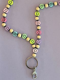 Dress up your work badge or keys with this colorful smiley face lanyard! This Listening Includes: One handmade lanyard made with... * Plastic Smiley Face Beads * Black Clay Beads * Wooden Beads * Key rings + lobster hook Materials: * Plastic * Clay * Wood * Metal Message me with any questions you may have :)  Please allow 1-2 days for the product to be made before the item will ship.  Thanks for checking out my shop! Smiley Face Beads, Beaded Lanyard, Work Badge, Teacher Lanyard, School Staff, Beaded Lanyards, Cedar Rapids, Black Clay, Happy Fun