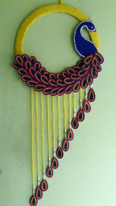 a colorful peacock decoration hanging on the wall