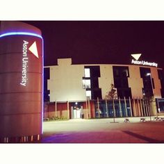 an illuminated sign in front of a building at night