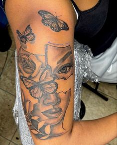 a woman's arm with tattoos on it and butterflies flying over her head in the background