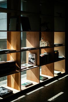 a bookshelf filled with lots of books next to a window