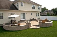 an outdoor patio and seating area in the back yard