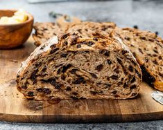 a loaf of bread sitting on top of a wooden cutting board