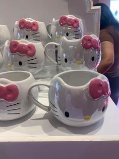 hello kitty coffee cups and saucers are on display