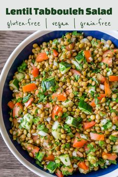 lentil tabbouleh salad in a blue bowl on top of a wooden table