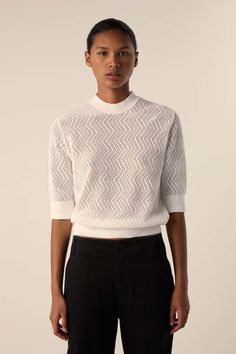 This knit sweater in zig zag pointelle is crafted to a slim short sleeve silhouette with small pointelle patterning throughout. completed with a mock neckline and solid knit trims.    cottn 100%    made in italy Sleeve Silhouette, Mock Neckline, Something Went Wrong, White Label, Proenza Schouler, White Sweaters, Designer Outfits Woman, Zig Zag, Black Sweaters