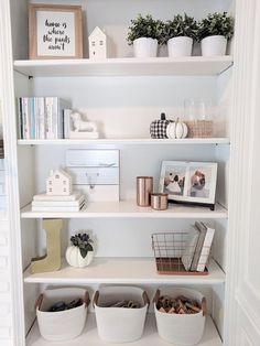 the shelves in this room are filled with baskets and books