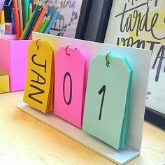 colorful desk calendars with the numbers one and two on them sitting on a desk