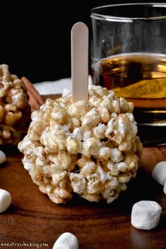 a caramel popcorn ball on a table with marshmallows