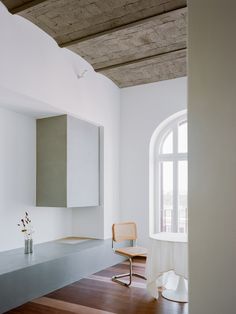 an empty room with white walls and wooden floors