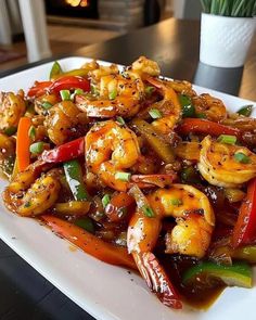 a white plate topped with shrimp and peppers