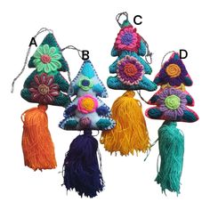 four different types of crocheted ornaments with tassels