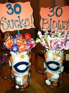 two mugs with candy in them are decorated to look like they have the words 30 sucks