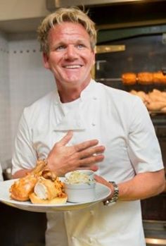 a man holding a plate with food on it