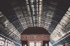 the inside of a train station with people walking around