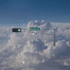 an image of the moon street sign above the clouds