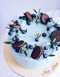 a cake decorated with blue frosting and cookies