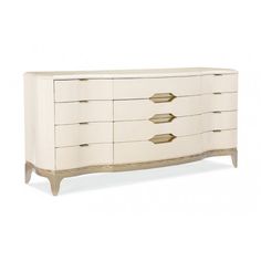 a white dresser with gold handles on it's sides and drawers, against a white background