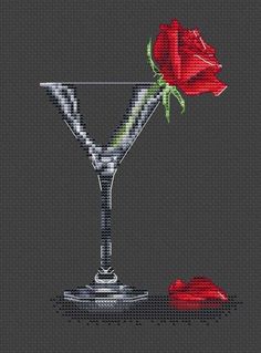 a cross stitch pattern with a martini glass and a single red rose on the side