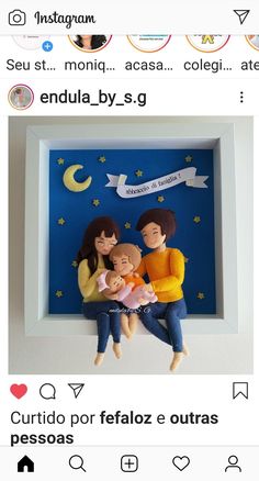 an image of two people holding a baby in front of a blue background with stars and moon