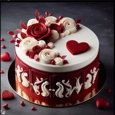 a red and white cake decorated with roses, hearts and swirls on a plate