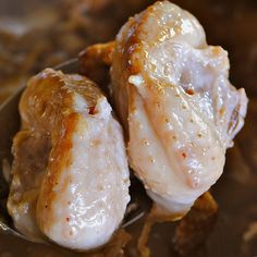 two cooked meats in a bowl with sauce on them, ready to be eaten