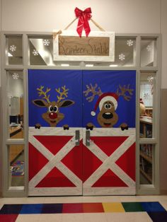 two doors decorated to look like farm animals with santa hats and reindeers on them