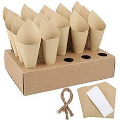 a cardboard box filled with paper cups and papers