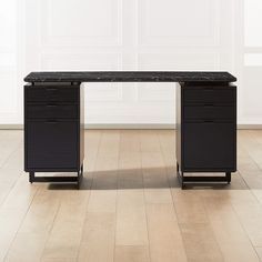 a black desk with two drawers and a marble top in an empty room next to a white wall