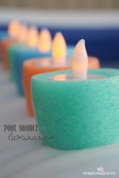 there are many different colored candles on the table