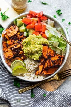 a bowl filled with rice, vegetables and guacamole