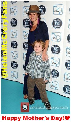 a woman standing next to a little boy on a blue carpet with the caption happy mother's day