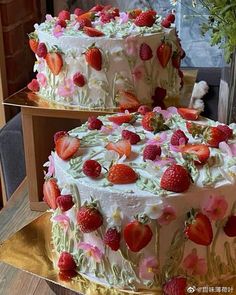 two cakes decorated with strawberries and flowers