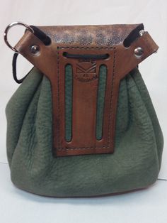 This sporran would be a great addition to your ren fest, sca, or cosplay costume. this belt pouch has a hand tooled flap and a pouch that is 8x8x4 for 256 cubic inches of space in side. This pouch has a draw string closer and a flap closer to keep your things dry and safe, I have been in the rain for hours and had my things stay dry. This pouch has a belt loop to slide on to your belt or D rings to put it on it's own belt or shoulder strap. All my products are hand made in the USA and have a 5 y Medieval Leather Pouch For Larp, Kilt Accessories, Leather Belt Pouch, Diy Leather Projects, Ren Fest, My Things, Leather Art, Veg Tan Leather, Belt Pouch