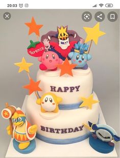 a three tiered birthday cake with cartoon characters on top and stars around the edges