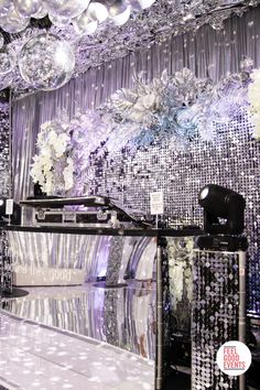 a room filled with lots of silver and white decorations